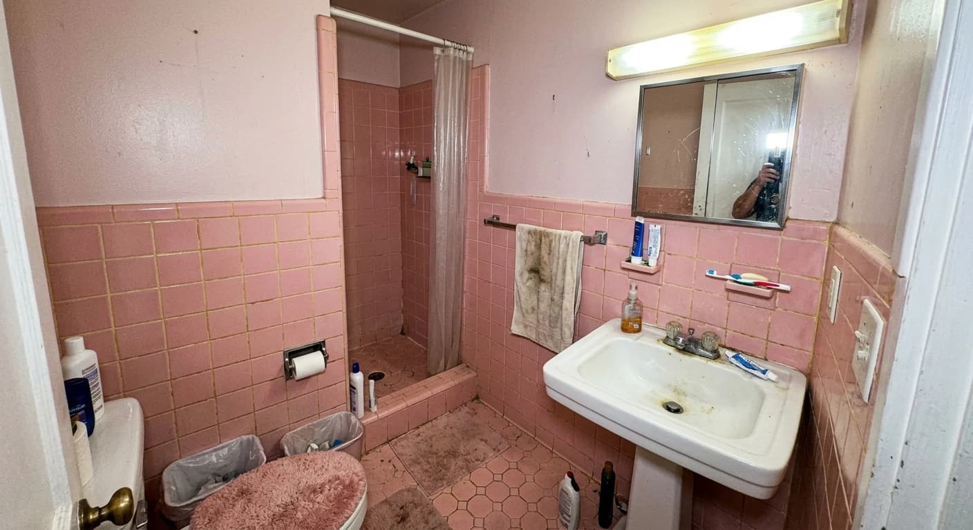 Denver bathroom before renovation, 1990s pink tile and builder-grade fixtures